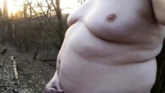 Chubby masturbates in the woods