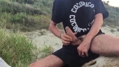 He wanks in the dunes